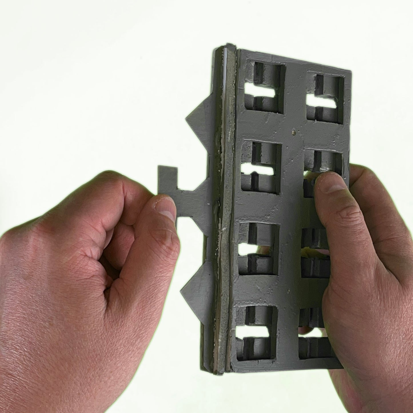 Grid connectors connect together grid bases in the TERRAINO Tabletop Terrain modular floor system.